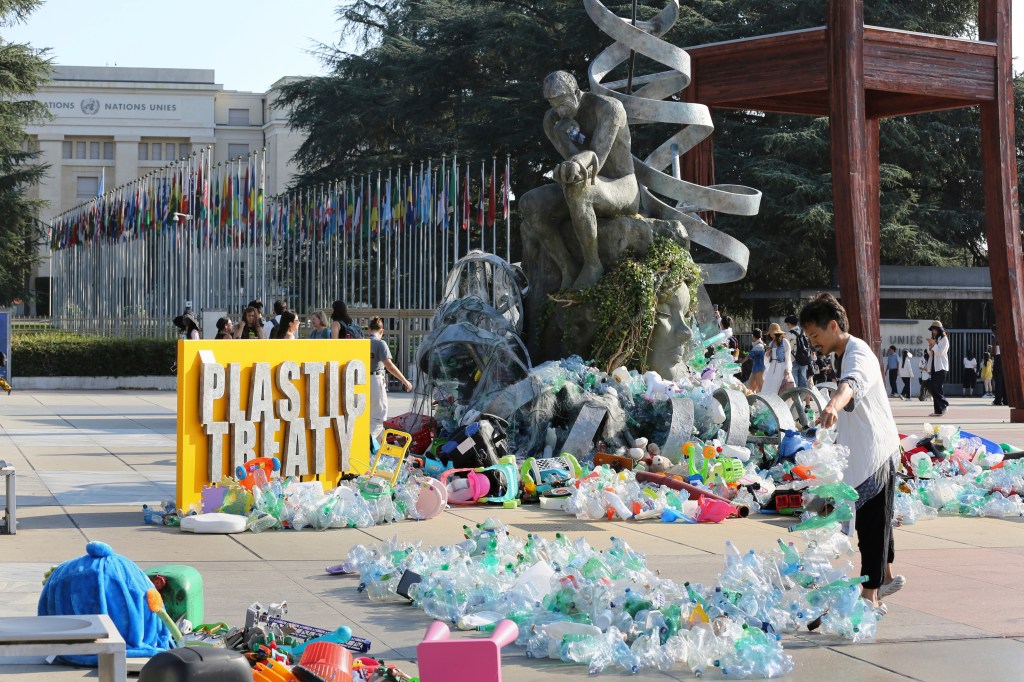 A large pile of plastic waste in front of the United Nations Office in Geneva.