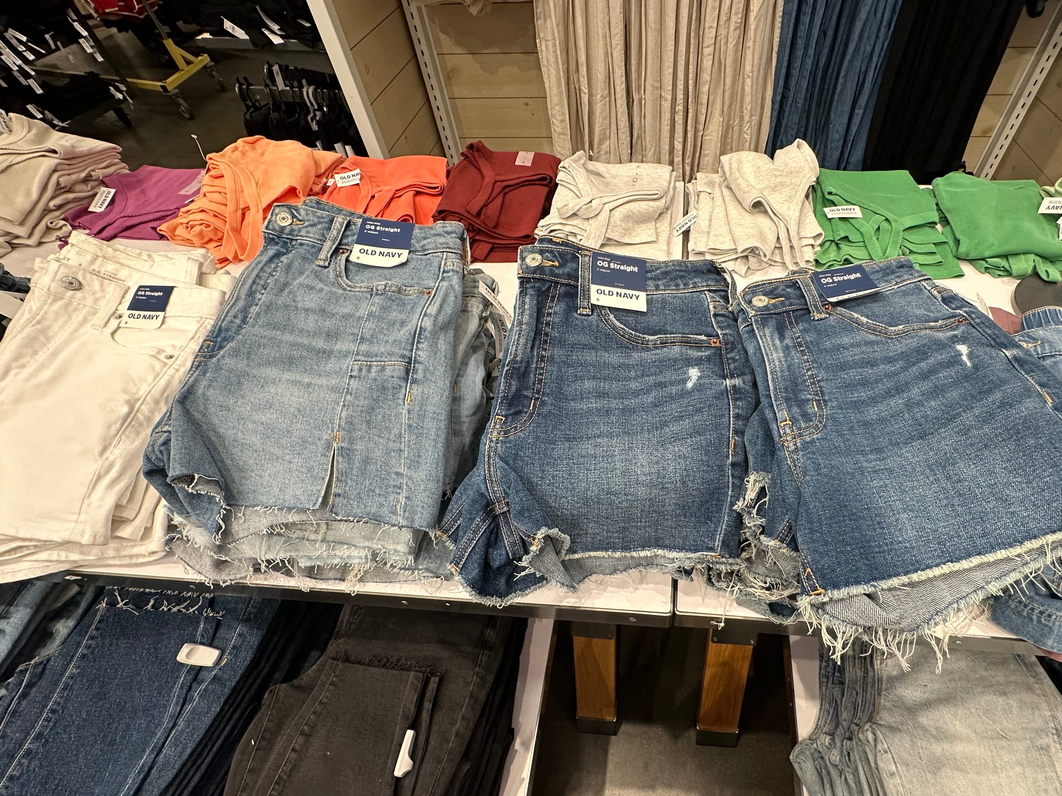 A row of shorts on a display table at Old Navy.