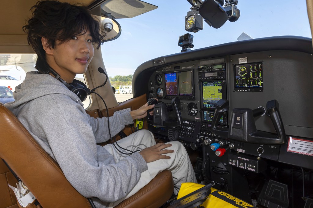 Teenage pilot in cockpit.