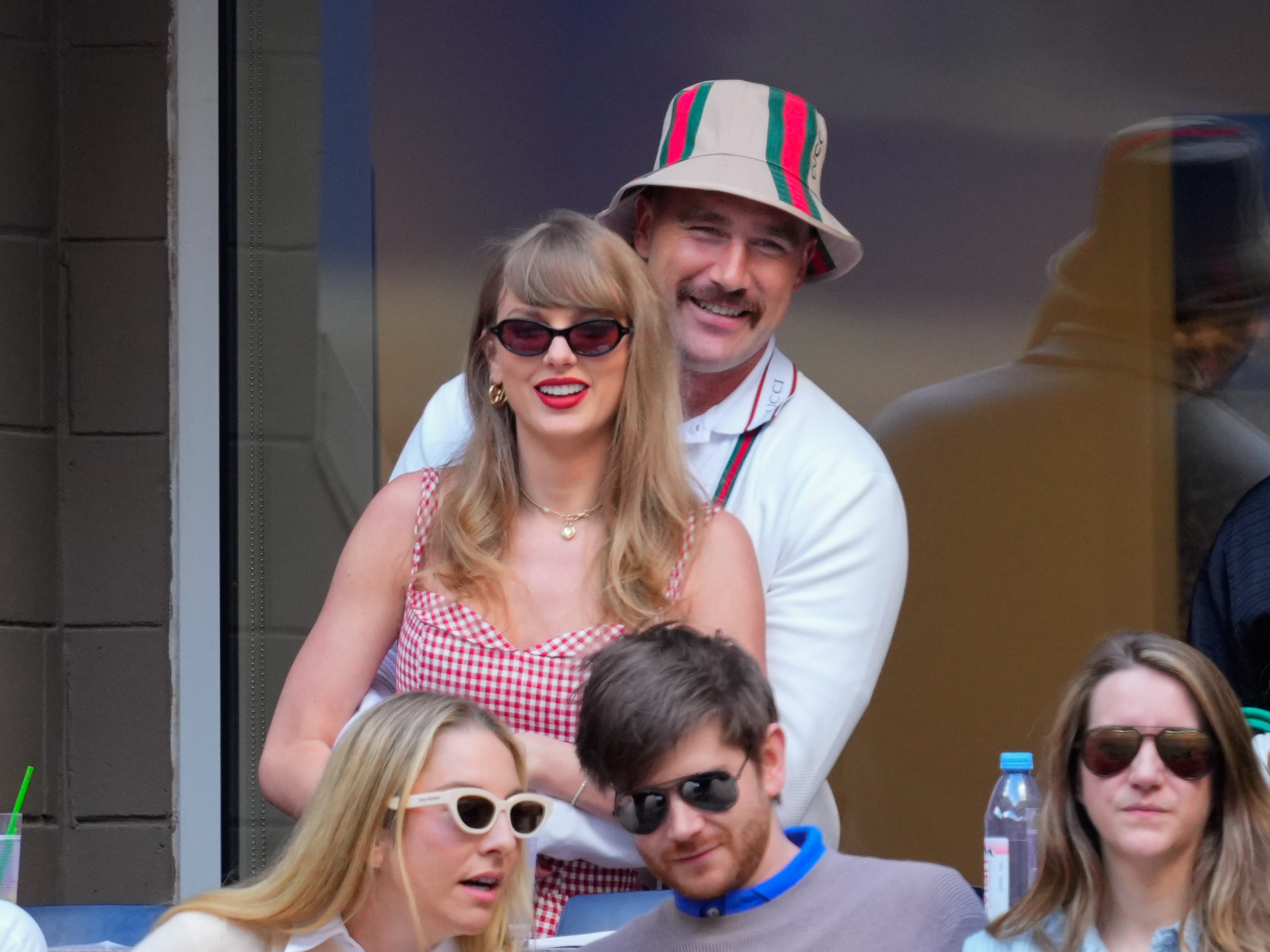 Travis Kelce hugging Taylor Swift from behind at the 2024 US Open Tennis Championships.