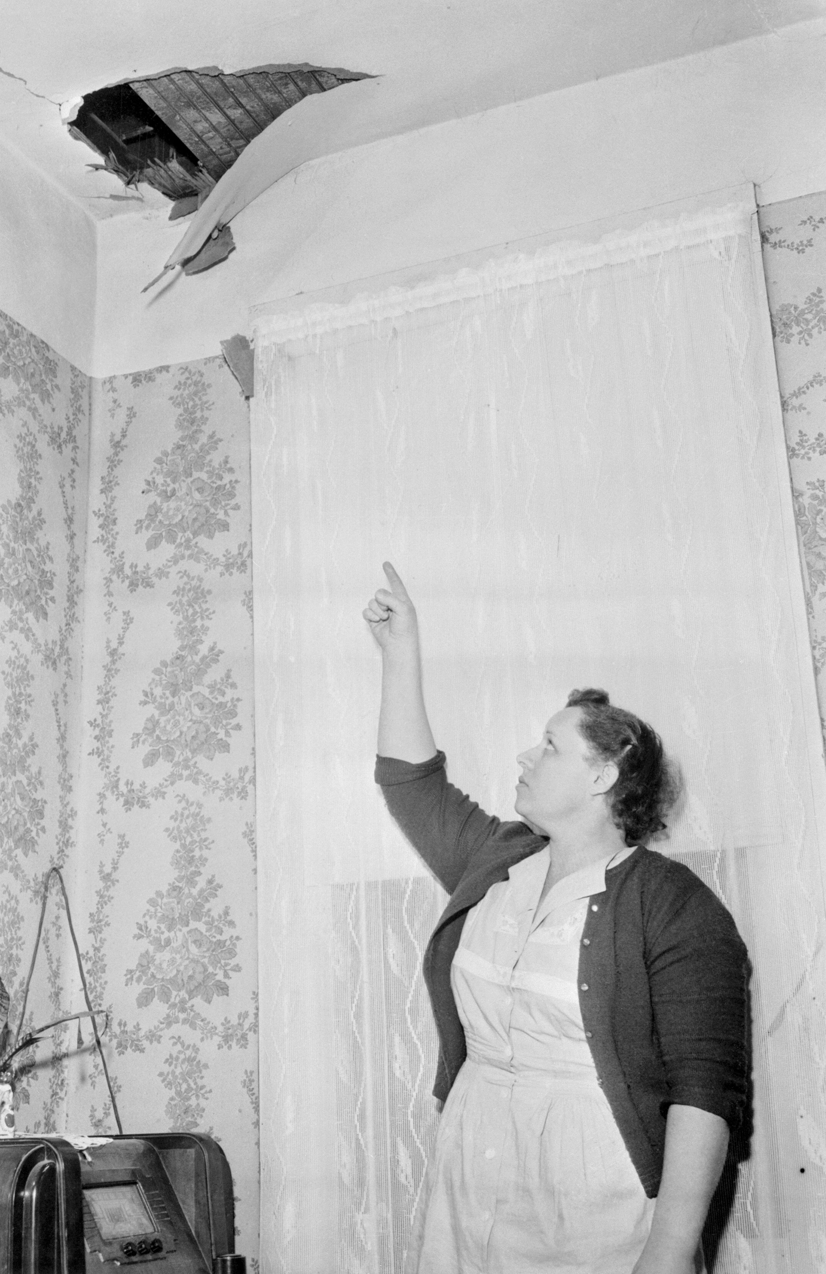 Ann Hodges points to a hole in her ceiling where a meteorite crashed through before hitting her.