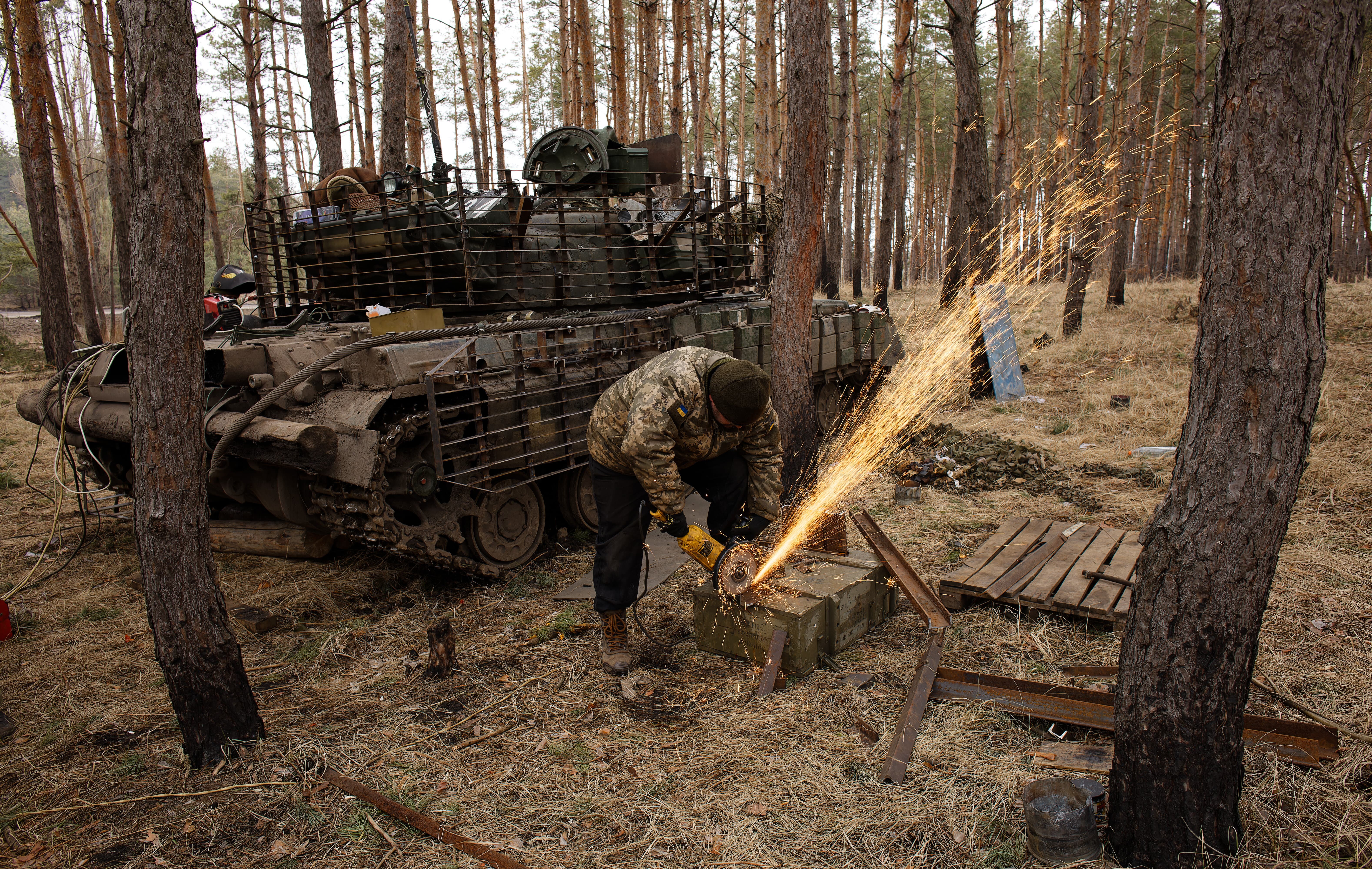 A repair battalion soldier of the Armed Forces of Ukraine prepares slat armor's elements for welding onto a T-64 tank on February 3, 2024 in Donetsk Oblast, Ukraine.