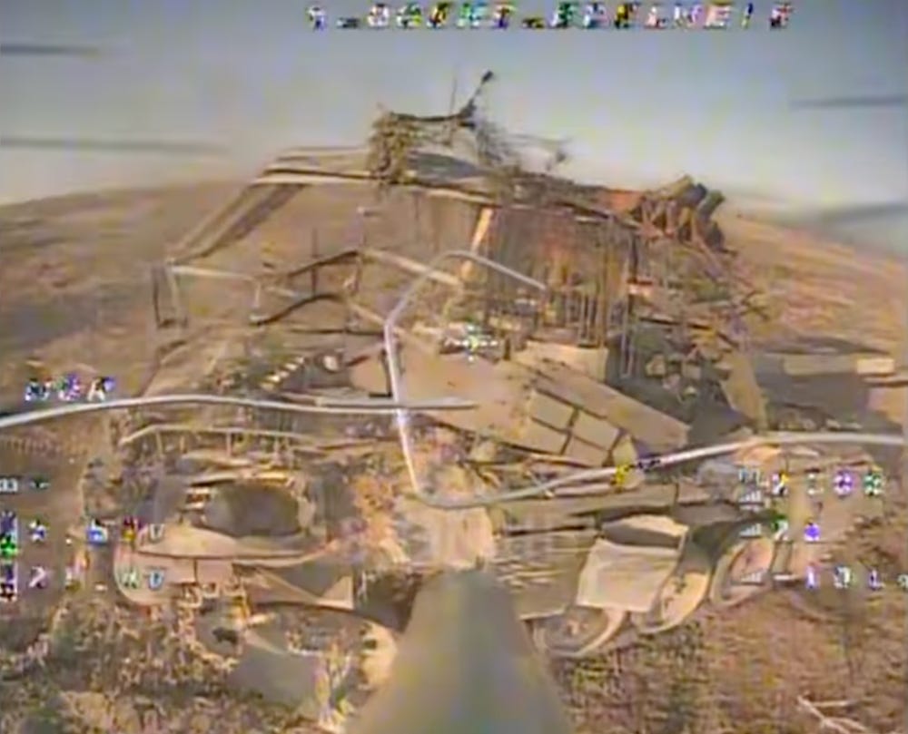 Video still taken from an FPV drone as it approaches an armored vehicle covered with a 'cope cage,' in footage posted by the 8th battalion of the 10th mountain assault brigade 