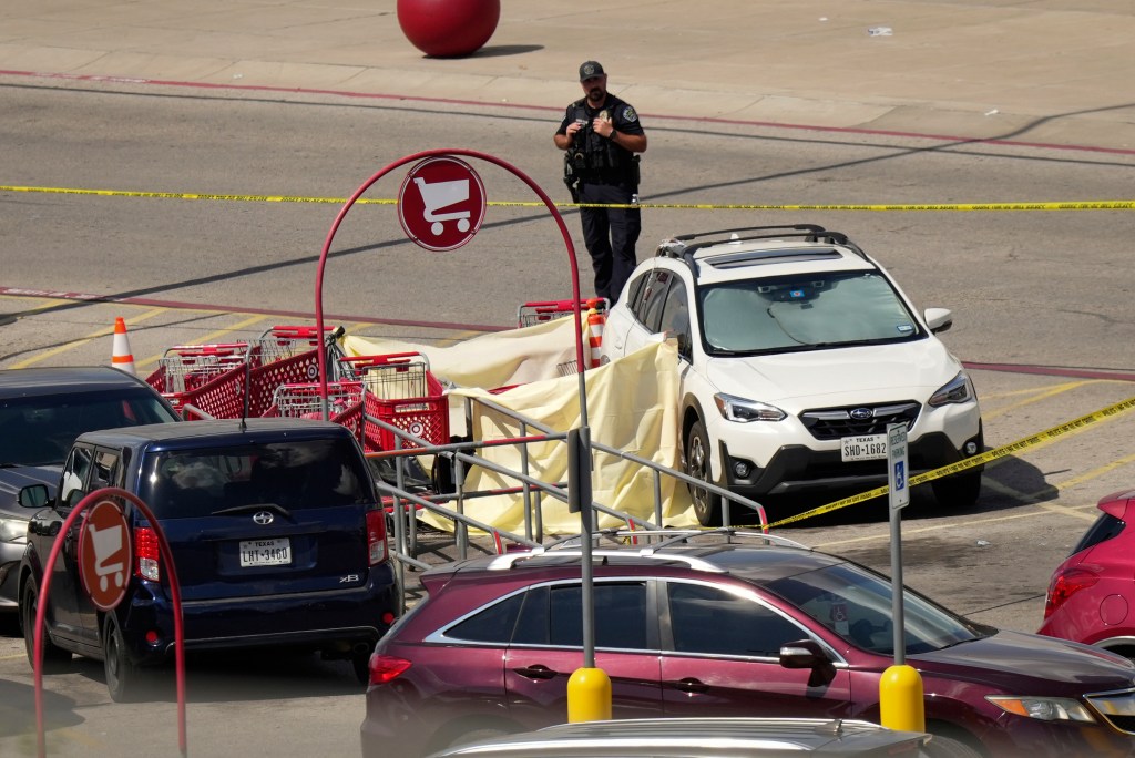 Police officer at a Target parking lot crime scene.
