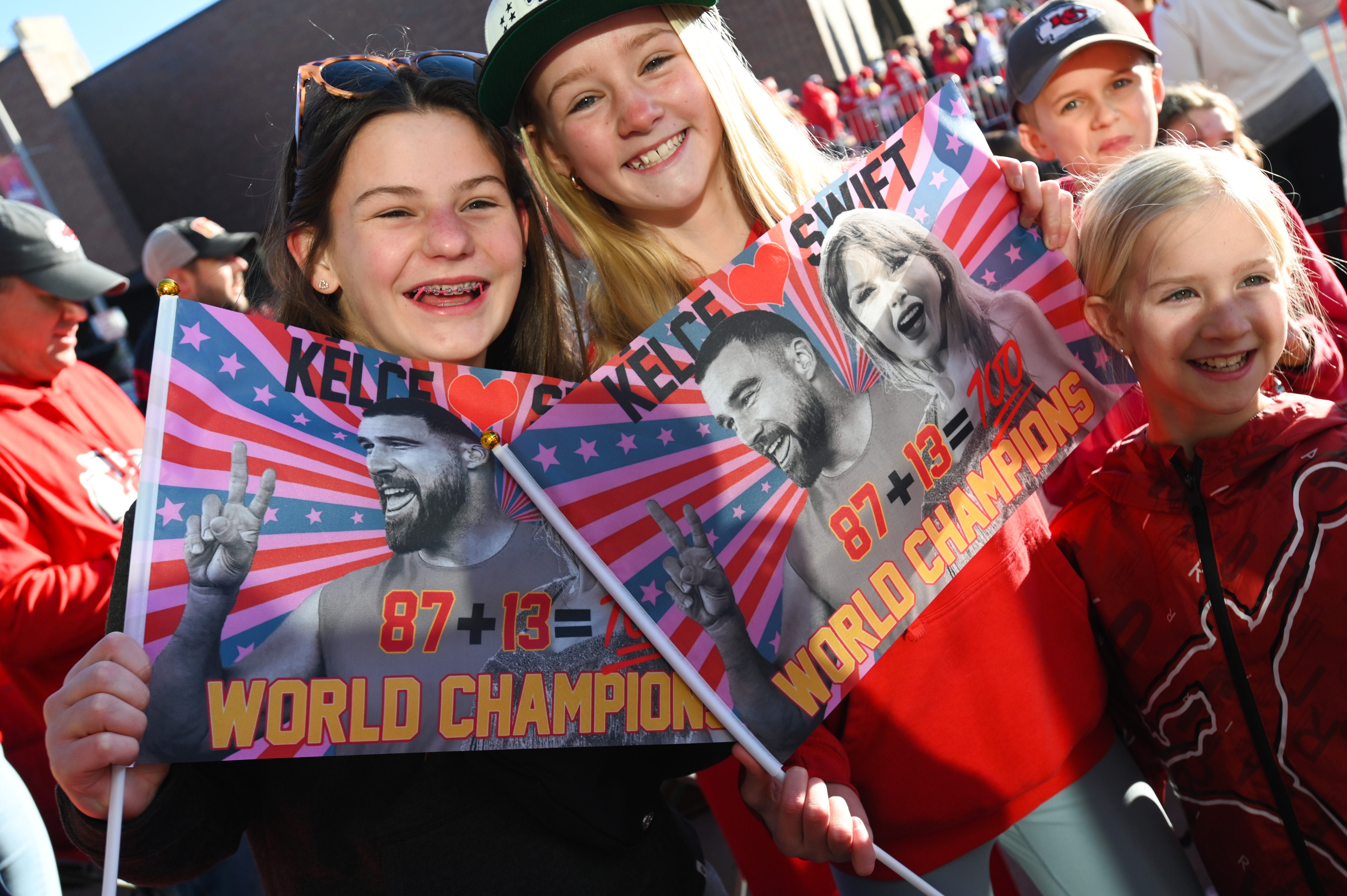 Fans support Travis Kelce and Taylor Swift at a Kansas City Chiefs game.