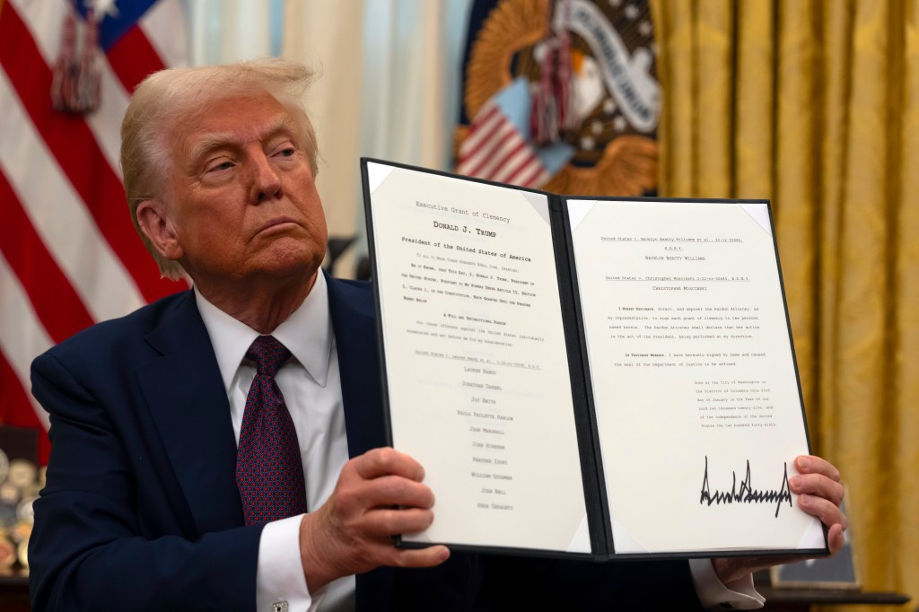 President Trump holding a clemency order.