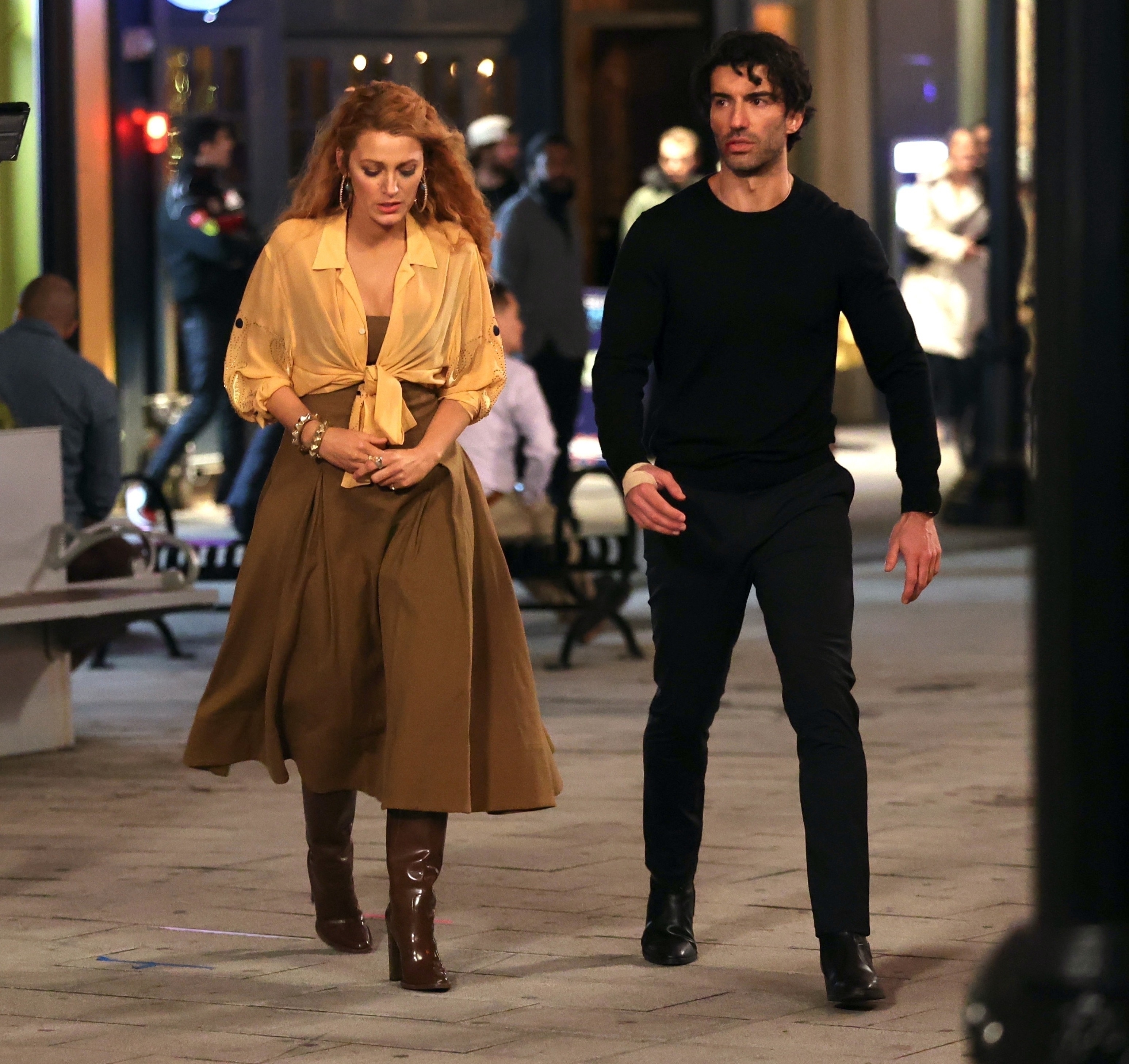 Blake Lively walks with Justin Baldoni. 