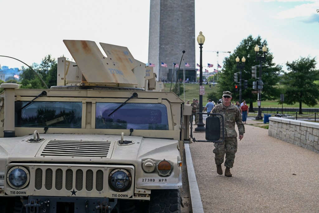 National Guard personnel walk the streets near the Washington Monument after being deployed by President Donald Trump.