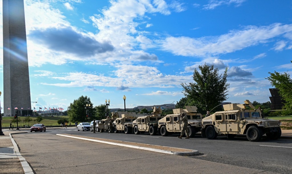 National Guard Humvees line up on the street near the Washington Monument. 