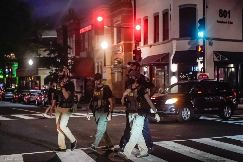 Federal law enforcement agents patrol at the intersection of 9th and U Street in the Shaw neighborhood of Washington, DC, on Aug. 12, 2025.