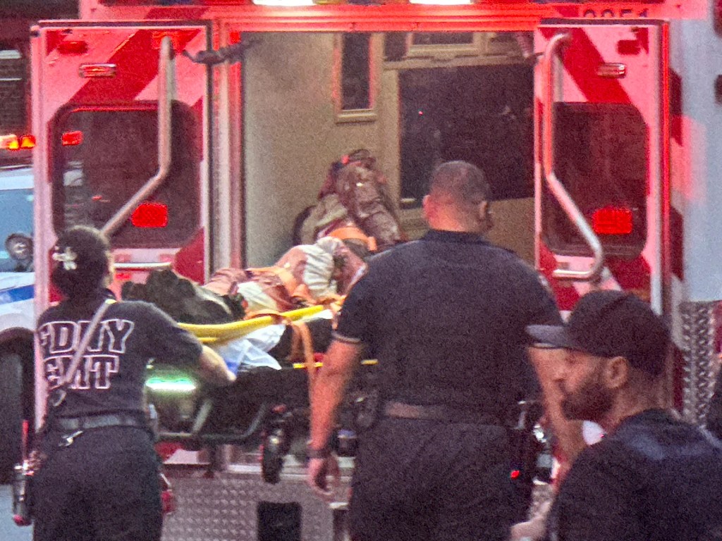 Man being loaded into an ambulance.