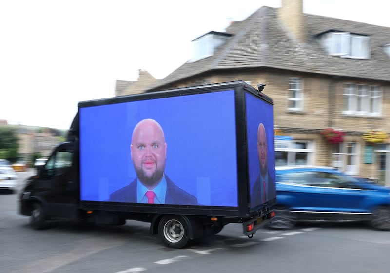 A van, displaying meme imagery of U.S. Vice President JD Vance, organised by the campaign group 'Everyone Hates Elon', travels through the town of Charlbury whilst Vance spends his holiday nearby, in Charlbury, Cotswolds, Britain, August 12, 2025. REUTERS/Toby Melville