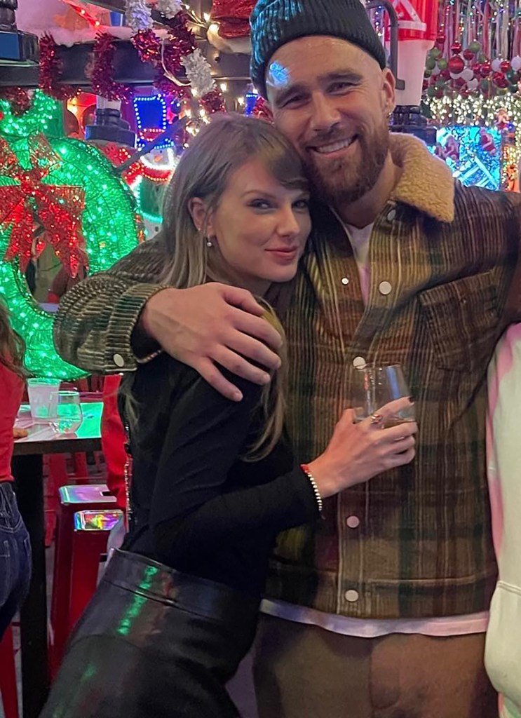 Taylor Swift and Travis Kelce pose together.