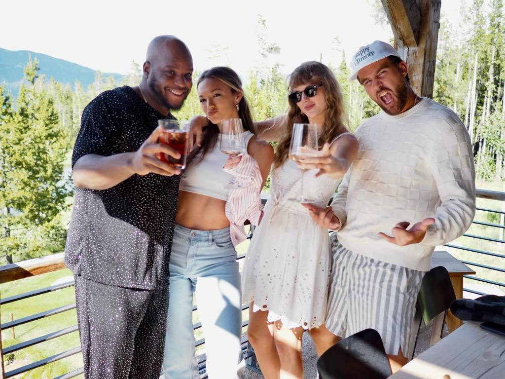 Travis Kelce and Taylor Swift posing with friends.