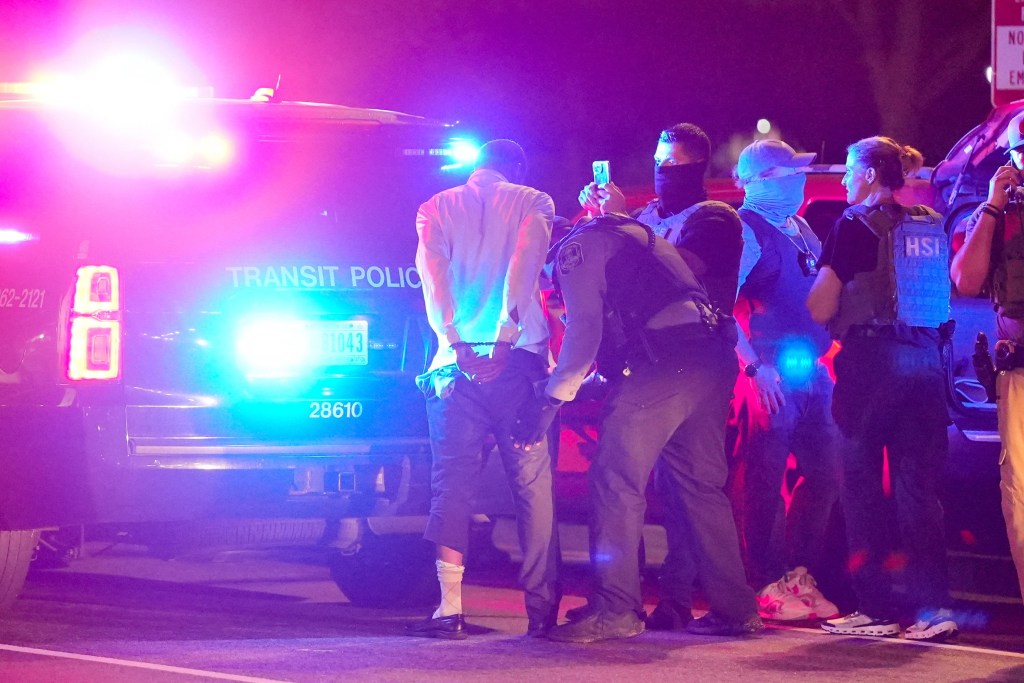 A driver is handcuffed by Metro Transit police during a traffic stop for a driver's license issue.