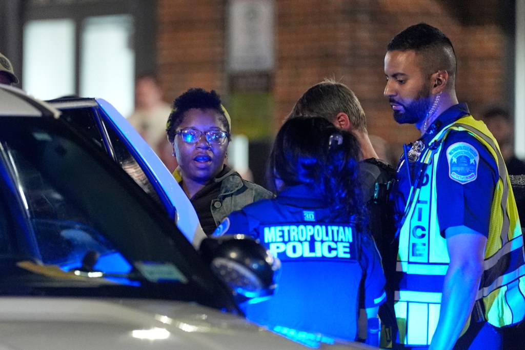 Metropolitan police detain a driver during the joint checkpoint on Aug. 13, 2025 on 14th Street in Washington, DC.