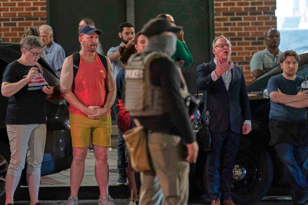 Protesters yell at federal agents on 14th Street during a joint checkpoint operation.