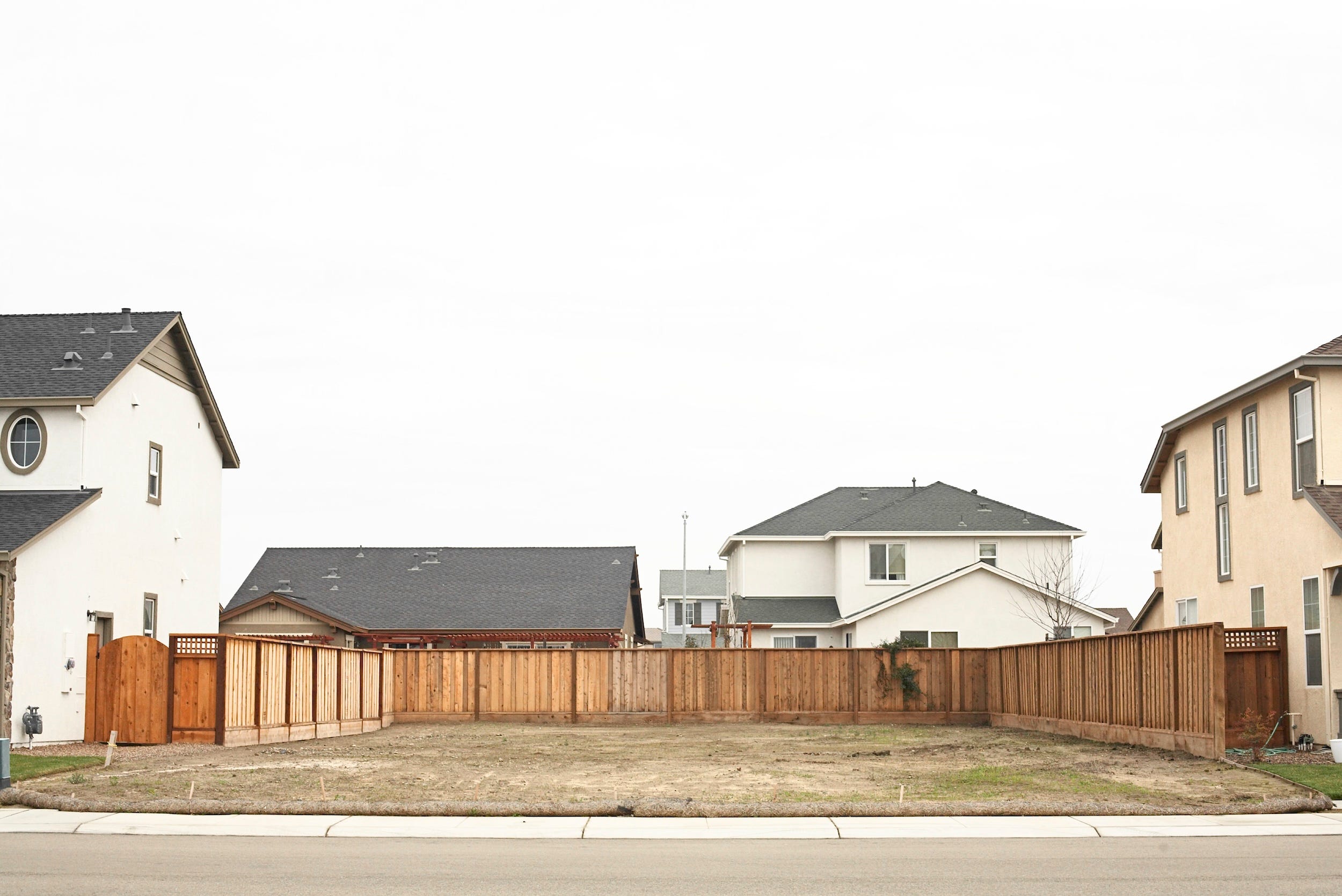 A vacant lot in between two houses.