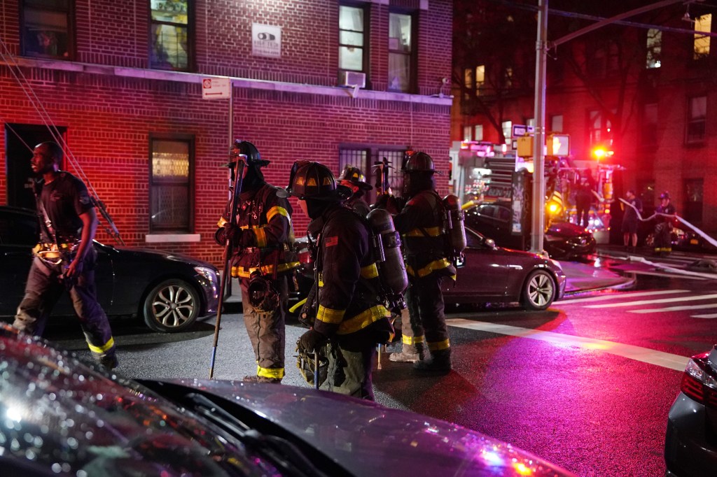 Firefighters on the street outside the apartment building where a fire was reported around 8:20 p.m.