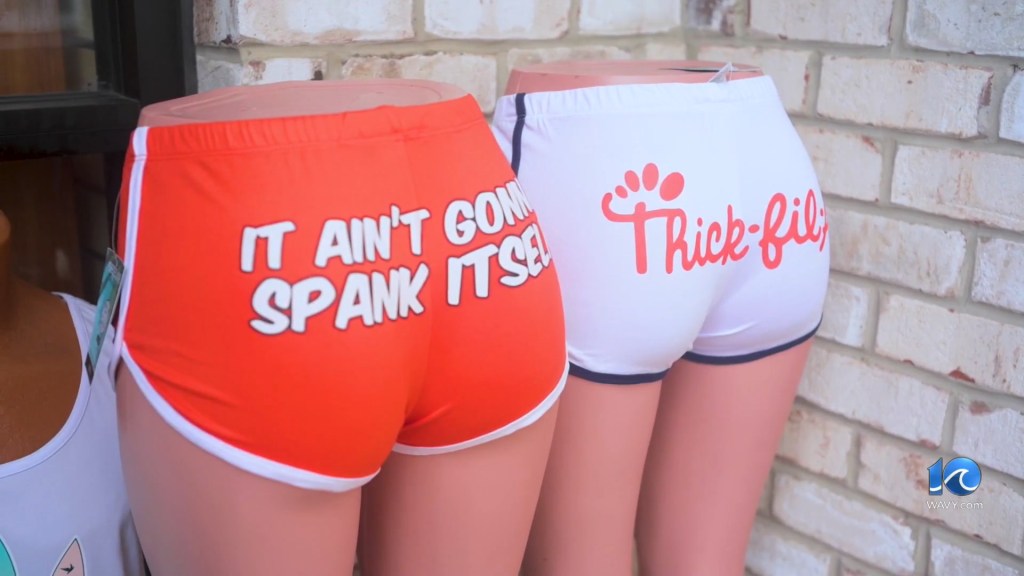 Shorts with words written across the back are displayed on mannequins legs at a Virginia Beach store.