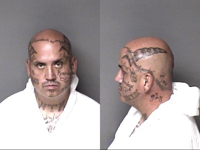Derek Hughes poses for a mugshot with displaying his facial tattoos after his arrest in Gaston County.