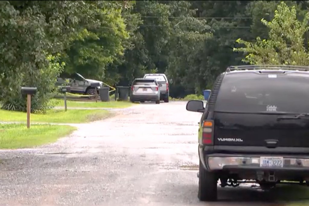 Police block off the driveway leading to the Gaston County where Steven Hughes was killed.