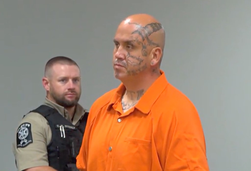 Derek Hughes appears in court after his arrest for allegedly murdering his father in North Carolina.