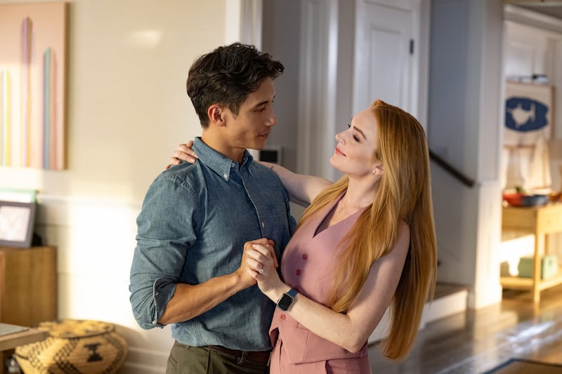 Manny Jacinto as Eric Davies and Lindsay Lohan as Anna Coleman