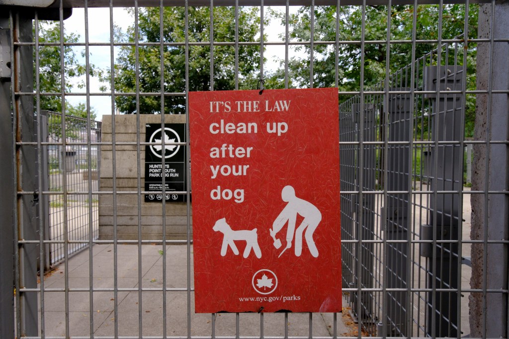 Signage urging dog owners to clean.