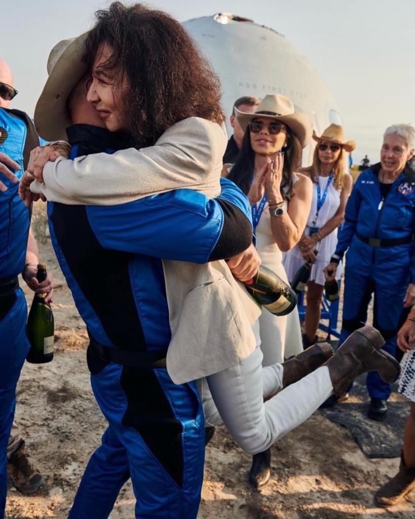 Jeff Bezos and his mother, Jackie Bezos, hugging.
