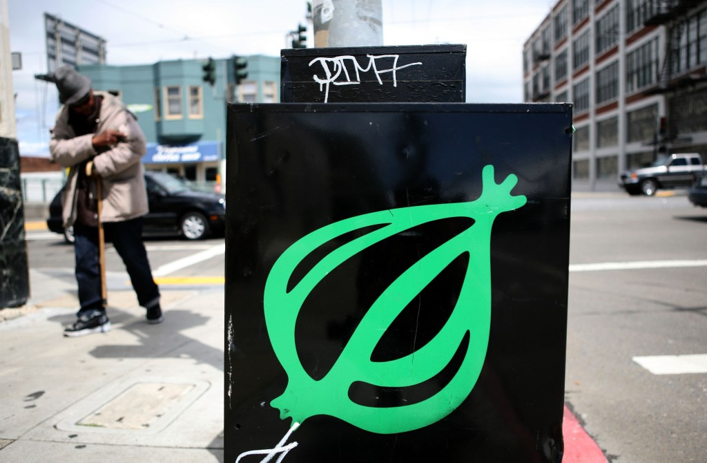 The Onion newspaper logo on a black street box in San Francisco.