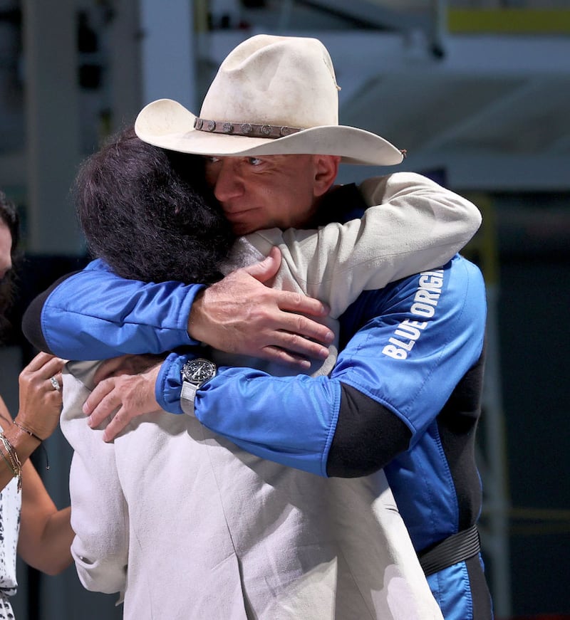 VAN HORN, TEXAS - JULY 20: Jeff Bezos hugs his mother, Jacklyn Bezos, after his flight on Blue Origin’s New Shepard into space during a press conference on July 20, 2021 in Van Horn, Texas. Mr. Bezos and the  crew that flew with him were the first human spaceflight for the company. (Photo by Joe Raedle/Getty Images)