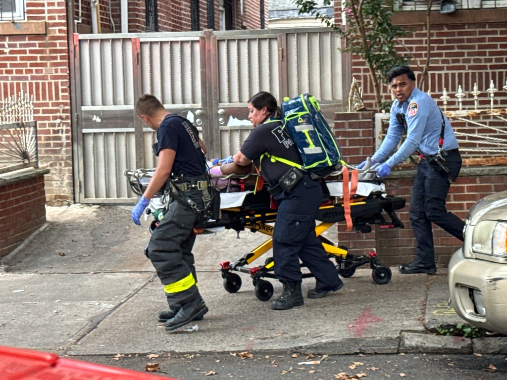 First responders moving a patient on a stretcher.