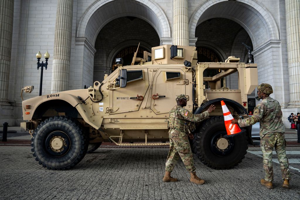 National Guard soldiers placing traffic cones around a military vehicle in Washington, D.C.