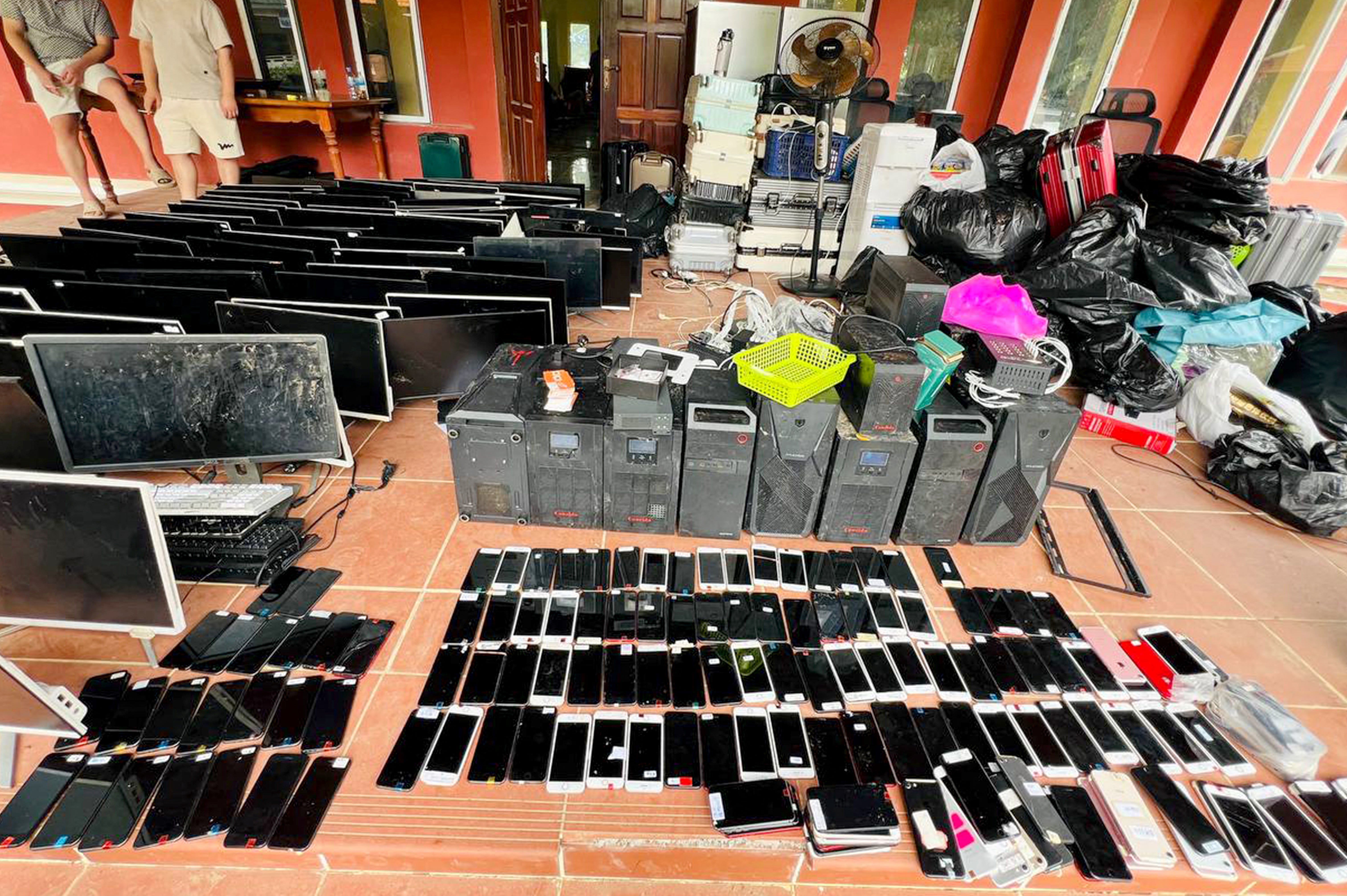 Dozens of phones and computer monitors are shown after being confiscated by authorities in Cambodia.