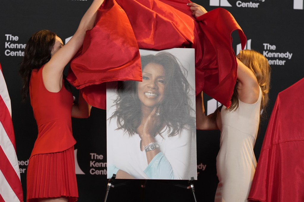 Two women unveil a portrait of Gloria Gaynor at the Kennedy Center Honors.