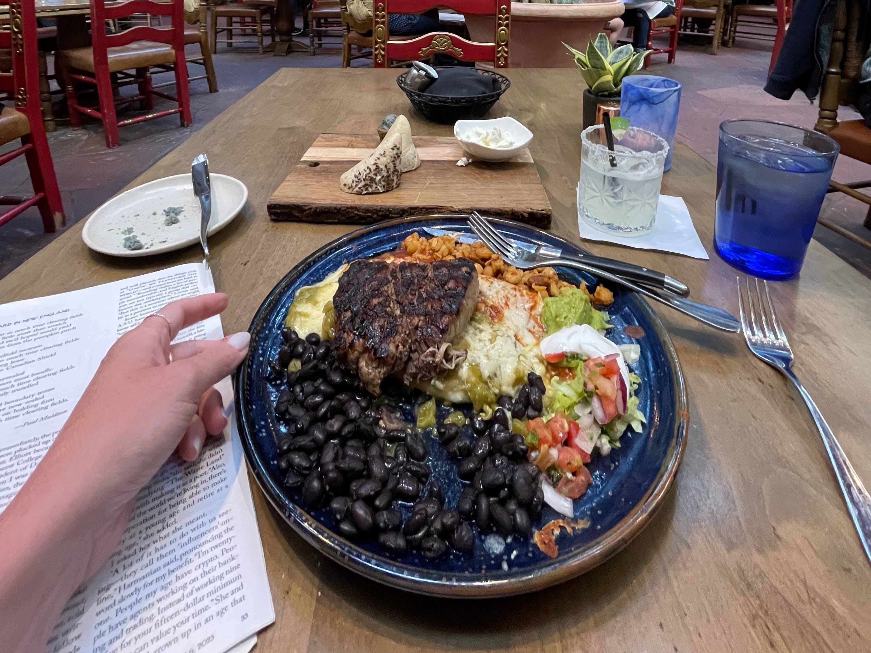 A traditional New Mexican meal on a blue plate in a restaurant.