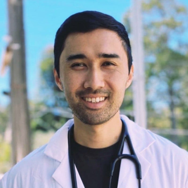 Dr. Keith Sakata wearing a lab coat and stethoscope.