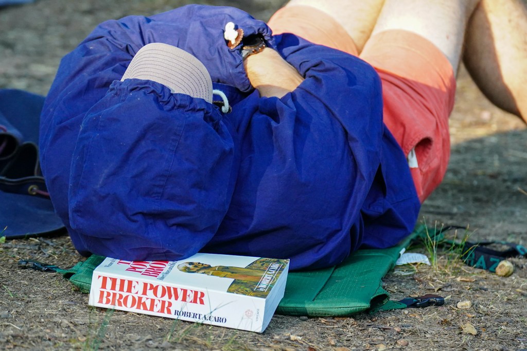 A woman sleeps on top of a book.
