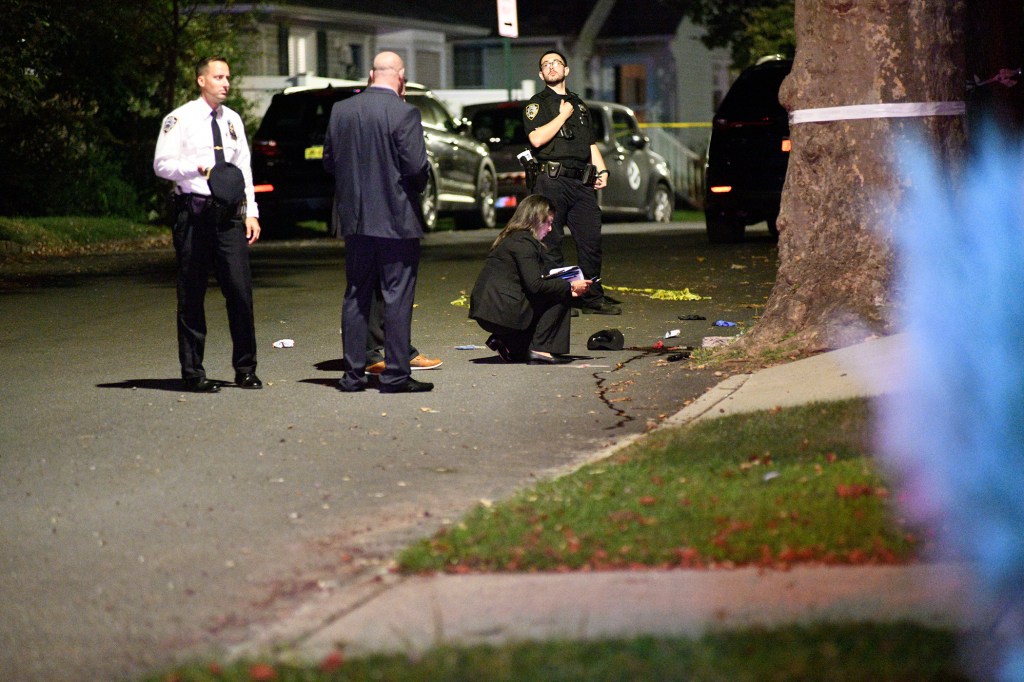 Crime scene investigators at a night-time shooting.