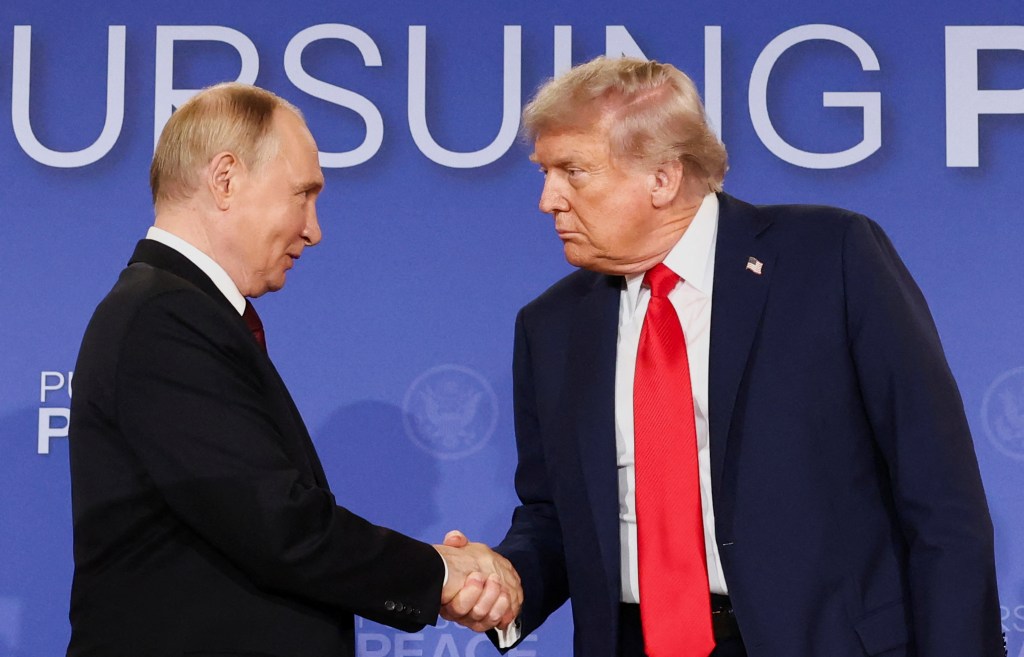 Presidents Trump and Putin shaking hands.