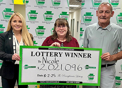 Nicole Walter holding a $2,021,096 Pennsylvania Lottery winner's check.