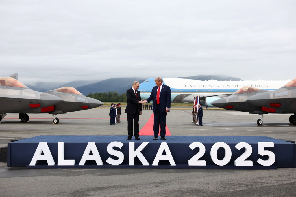 President Trump and President Putin shaking hands in Alaska.