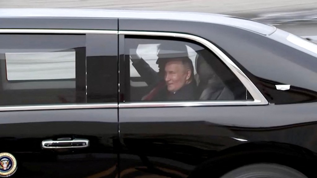Trump and Putin laughing in a car.
