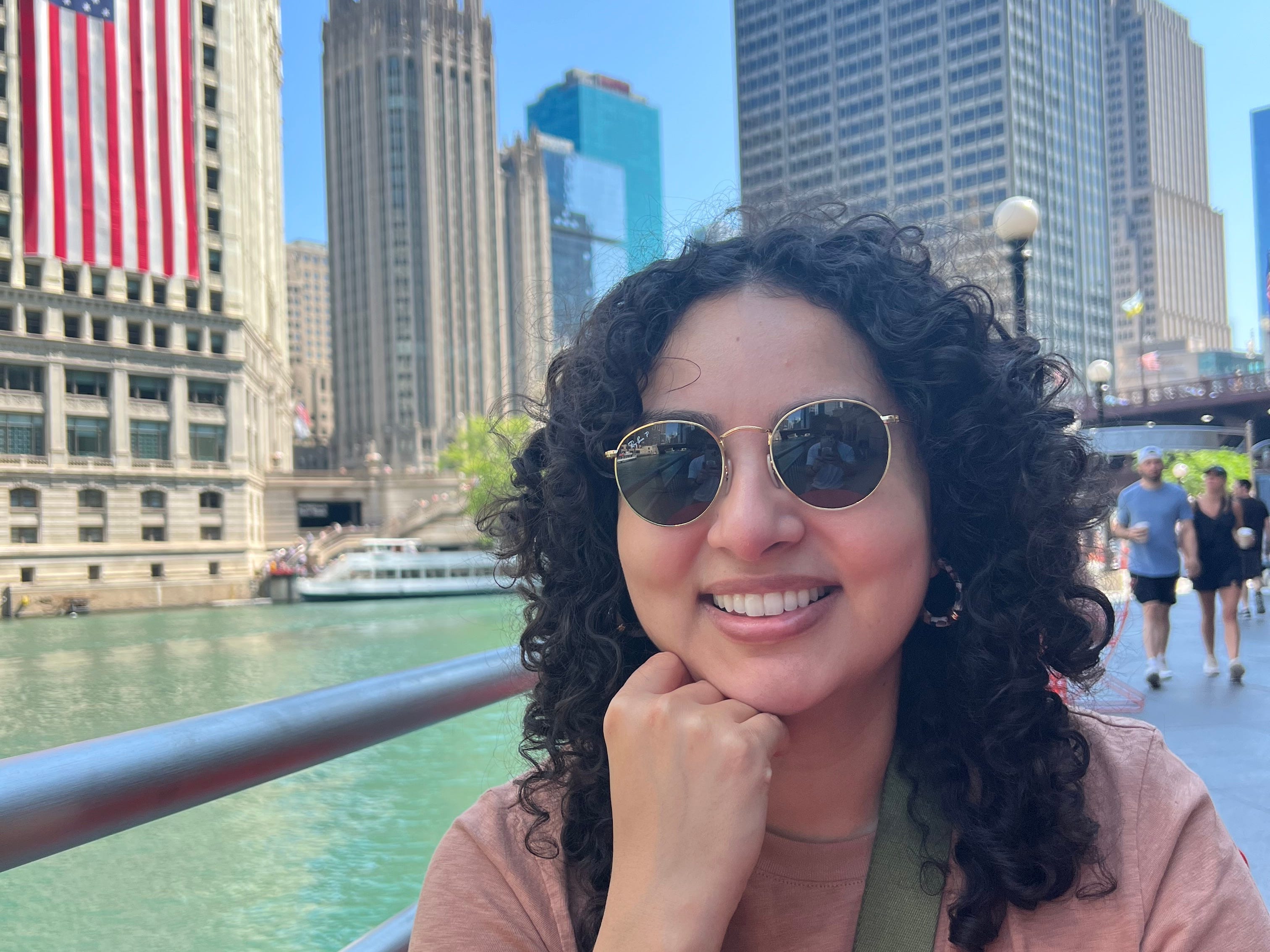 Giovanna Gonzalez in Chicago in front of an American flag.