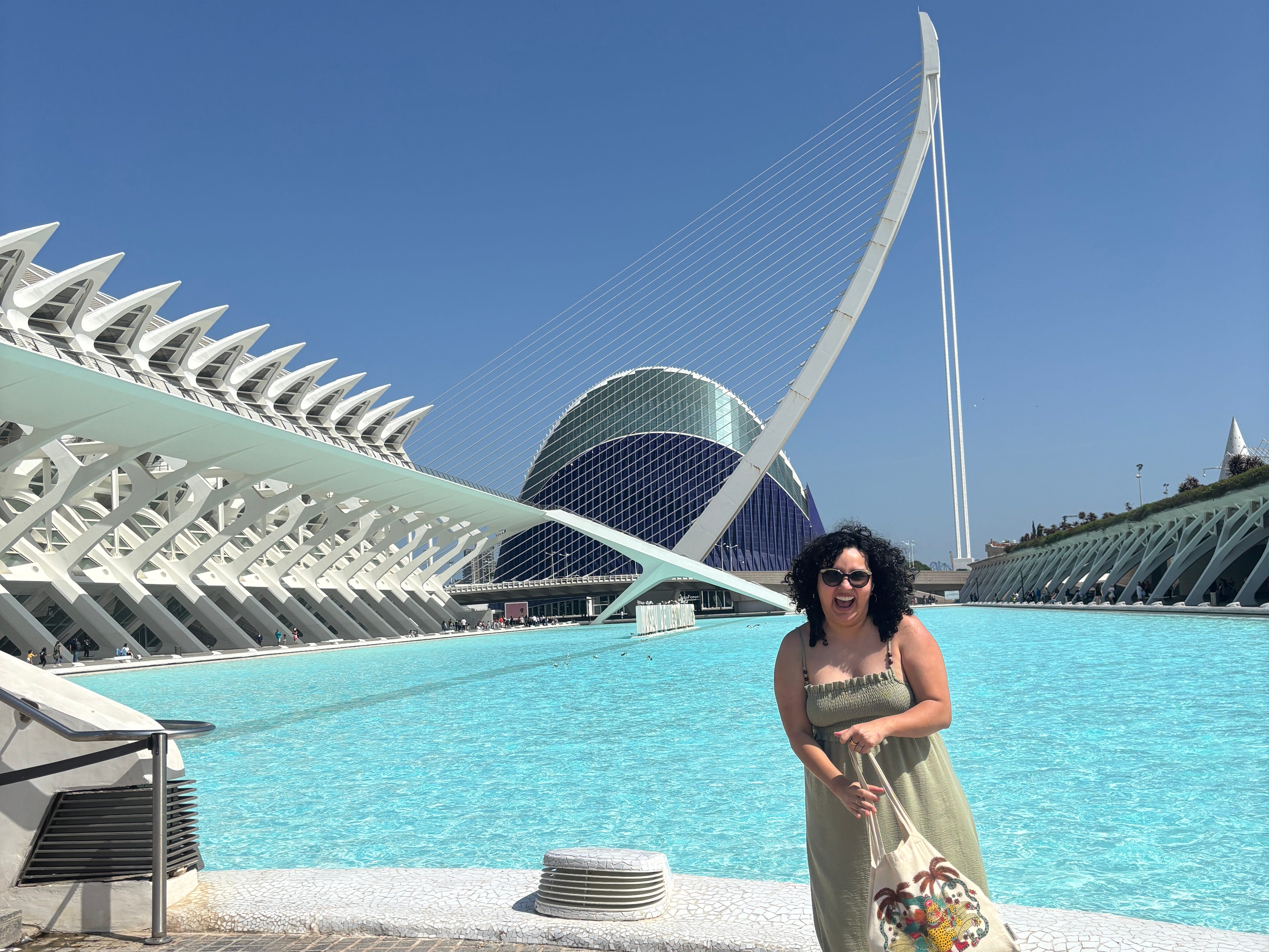 Giovanna Gonzalez in front of the Assut de l'Or Bridge and the L'Àgora building in Valencia, Spain.