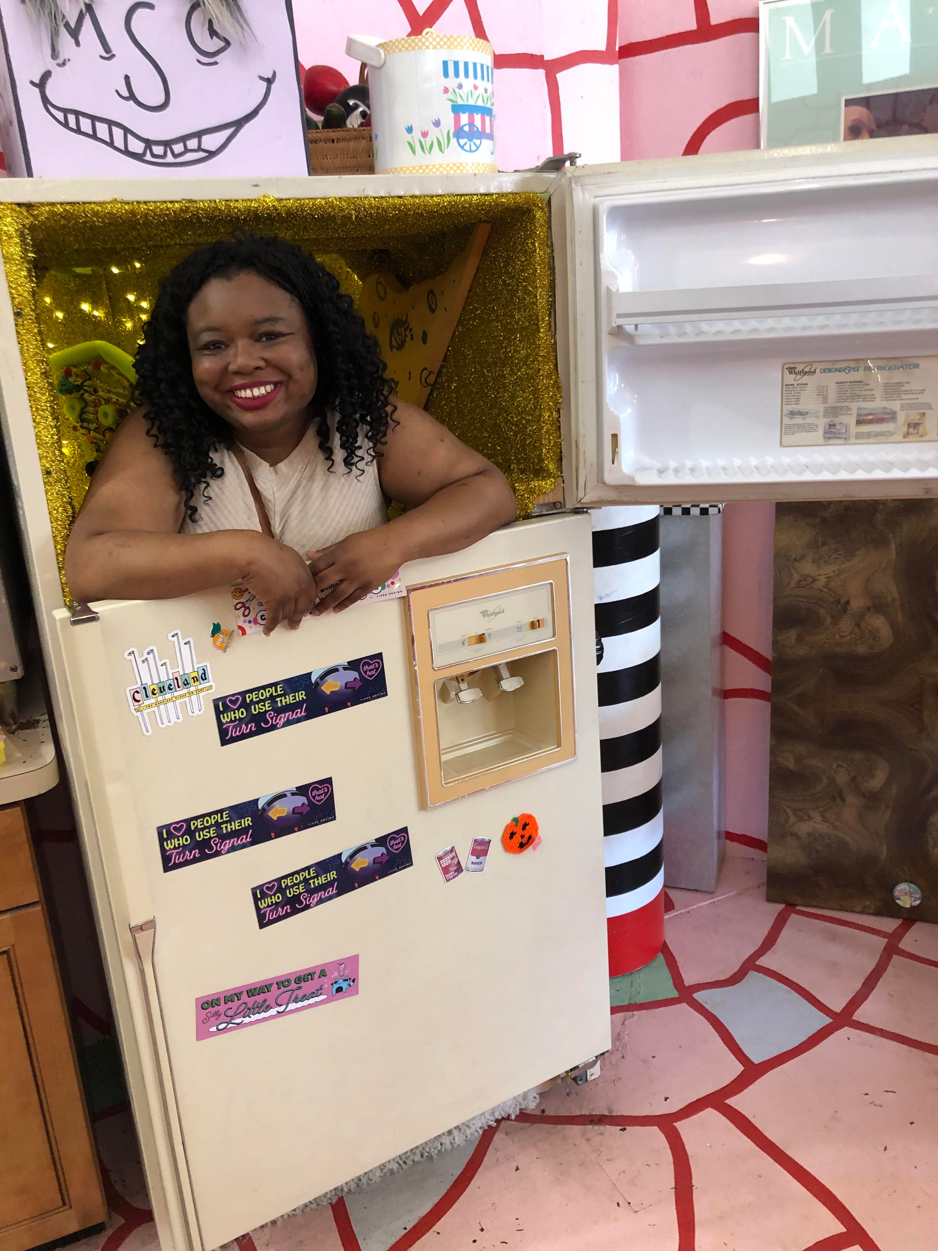 person inside of a hollowed out refrigerator