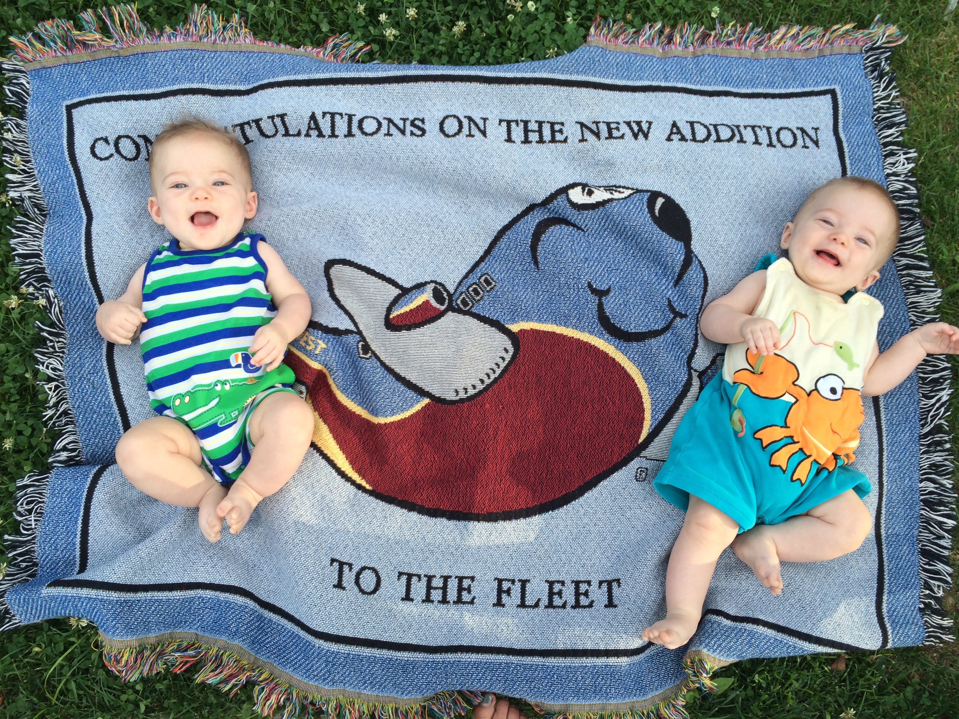 kim cooper's twins laying on a blanket that reads 