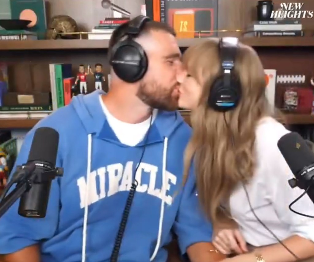 Travis Kelce and Taylor Swift kissing.