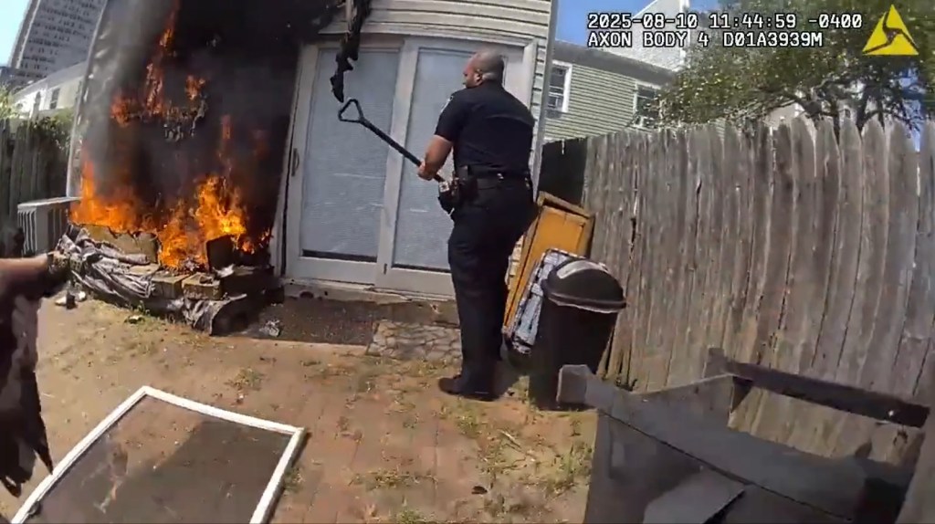 NYPD officers rescuing people and a dog from a house fire.